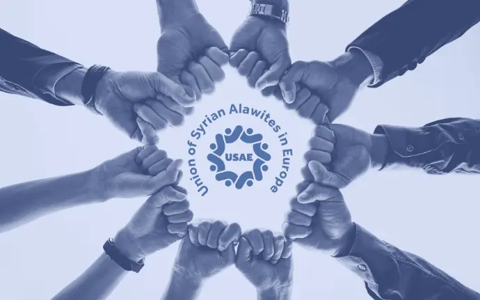 A group of people with their arms outstretched and fists closed, forming a circle with their arms.